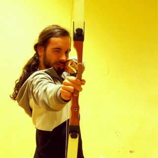 An archer - I am trying to shoot my own mirror reflection. I have learnt traditional archery skills.